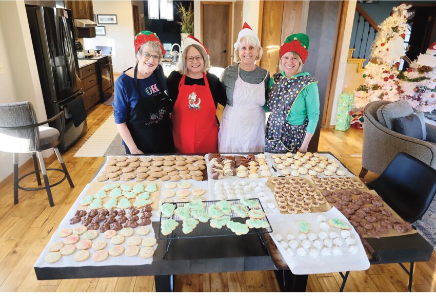 Julianne Stahl, Kathy Haar, Nancy Schmidt and Marlene Pidde gather around a table full of sweet treats during their all-day baking extravaganza on Wed., Nov. 29 &mdash; something these childhood friends have been doing annually for 20 years.