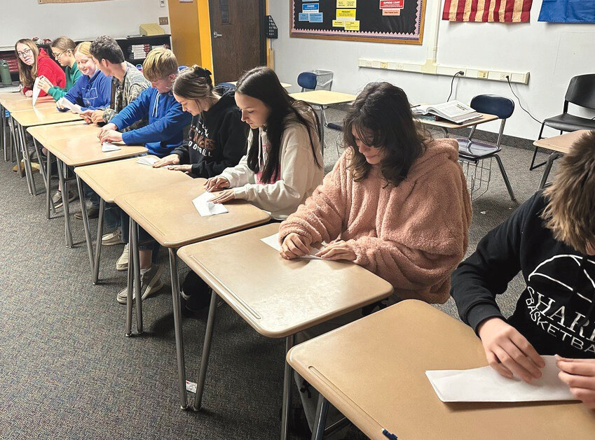 Iroquois High School sophomores in Zachary Wipf's class are learning about the Industrial Revolution. They mastered the assembly line, made famous by Henry Ford and Ford Motors. They also mastered the craft of folding paper airplanes, one fold at a time.