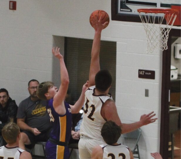 De Smet's 6-foot-8 sophomore Grant Wilkinson (32) dominates inside, rejecting this shot during last Tuesday's matchup with Flandreau in the Dog Pound. The Bulldog defense held the Fliers to just 29 points, finishing 50-29. (Photo by Amber Jensen)