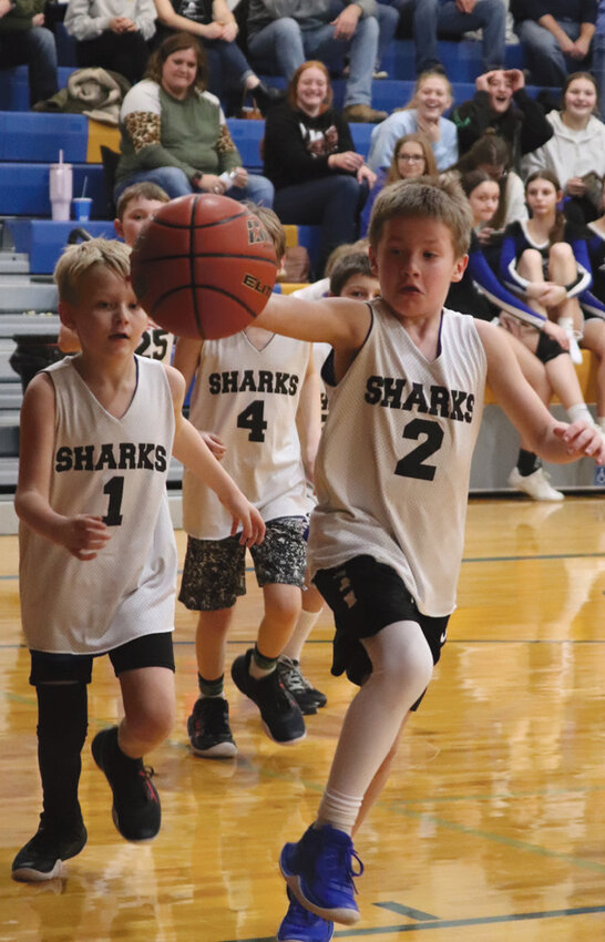 The Junior Sharks provided halftime entertainment during a basketball game last night. Pictured left: Luke Dykstra (1) and Layton Peskey (2) and pictured right are Jase Blasdel and Taz Menzel.