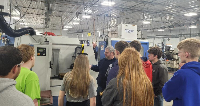 Jason Paul of 21st Century Manufacturing explains the ins and outs of the machines and robots they use to build products to Career and Technical Education program students.
