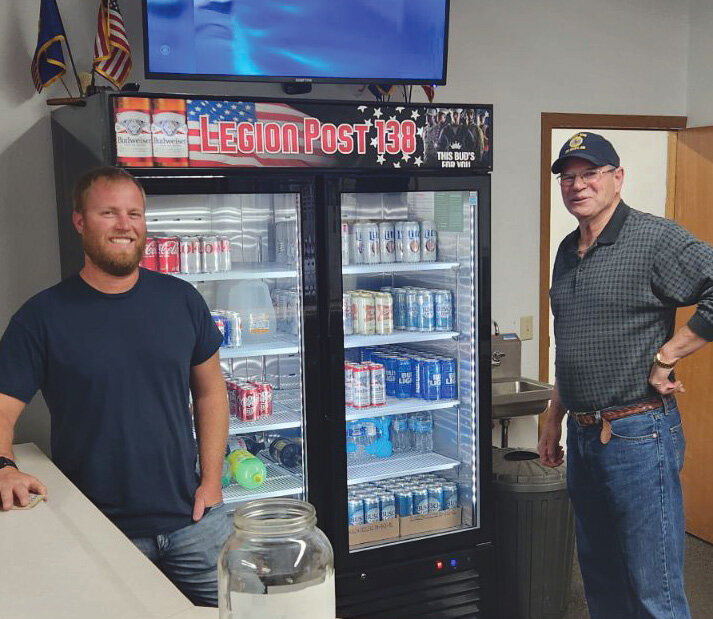 Seth Wallen and Randy Beck stand by the new beverage cooler.