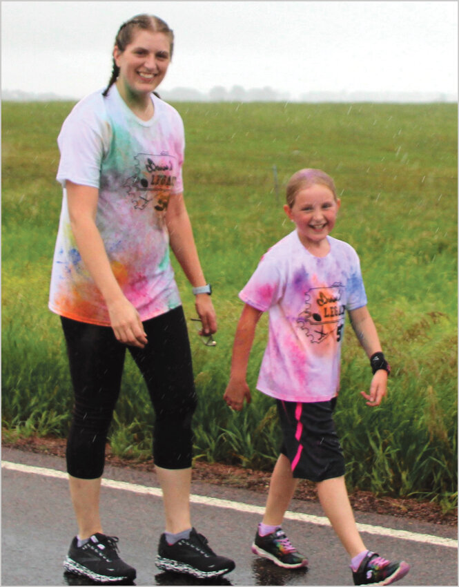 Raygan Sherman and her mother, Kimberly (Bornitz) Sherman, ran into some color powder and rain during the 5K. Raygan finished first among the youth runners and was fifth overall.