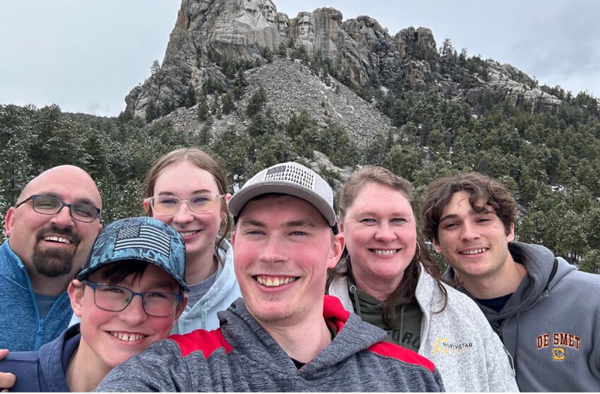 Jim, left, Grayson, Leah, Logan, and Julie Millman, along with foreign exchange student Melville Deloye at Mount Rushmore.