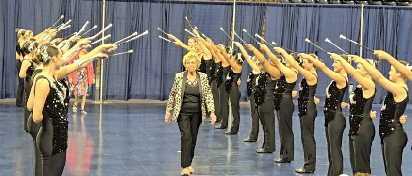 Walking under a baton arch as she is introduced as one of the top NBTA dignitaries at the National Baton Twirling Championships Awards Show on Saturday at Notre Dame University, Phillip J. Purcell Arena, South Bend, Ind., is Major Joanne Schlueter from Iroquois. Schlueter spent last week on the Notre Dame campus with family members as she is a member of the World Baton Twirling Federation Team organizing the competitions to determine the individuals and groups who will represent the USA at the World Baton Twirling Championships in Torino, Italy, in August 2025. Her sister, Rita Anderson, is also a part of this team and was an official judge at the week-long baton championships.