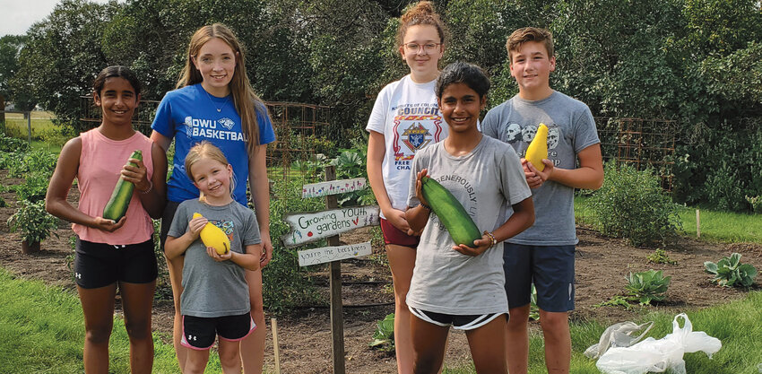 After doing some weeding on Mon., July 22, some of the youth at the Growing Youth Garden show off their produce. From left: Skylar Bendorf, left, Harper Anderson, Lizzie Griffith, Lyla Schoenfelder, Elizabeth Bendorf and Grant Griffith.