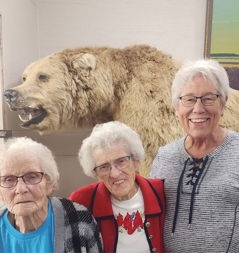 Mary Wienk, left, Ellen Halter and Dianne Larson went to Webster to visit the Wildlife, Science and Industry Museum. On display at the museum is the World Record Alaskan brown bear, shot by the late George Larson in 1967.