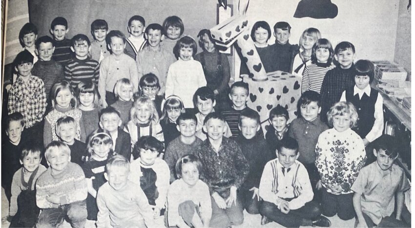 FIFTY-FIVE YEARS AGO: Strange animal visits first-grade rooms, swallows Valentines, lost among children anxious to be in photo. A strange animal has been visiting the first-grade rooms at Laura Ingalls Wilder Elementary School here &ndash; a Valentine-visiting giraffe named Snoopy. Snoopy has a way all his own. He does not take the Valentines from the children but will swallow them when they are placed in his mouth. Legs made of 14-quart oil cans, body from a cardboard box, his neck a 5 1/2-gallon plastic bottle and head a shoebox &ndash; such is Snoopy. A product of Mr. &amp; Mrs. Kenneth Glover, she a teacher&rsquo;s aide in the school.  The News camera went a-visiting when the appearance of Snoopy was reported, and what was to have been a picture of a few developed into a full-class picture after Dale Coughlin was prevailed upon with questions: &ldquo;Will the picture be in the paper?&rdquo;  The result is this large group of smiling faces, with Snoopy but partially shown &ndash; very likely forlorn over this loss of attention. Mrs. Lyle Lester and Miss Bernice Larson teach the two first-grade rooms.