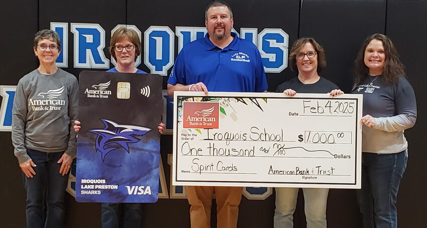 In response to the increasing budgetary needs of our local schools, American Bank &amp; Trust was inspired to give back to communities through Spirit Cards. The Spirit Card is a debit card that showcases the school district&rsquo;s name, colors and mascot. When American Bank &amp; Trust account holders make a purchase with their Iroquois/Lake Preston Sharks Spirit Card, AB&amp;T donates a percentage of money back to the Iroquois and Lake Preston school Districts. Since 2022, schools have received a total of $3,500. Representatives from the AB&amp;T Iroquois Branch presented a check for $1,000; these funds will be used to purchase a new squat rack for the weight room. If you would like more information on how you can help support the Iroquois School District by simply swiping your debit card along with showing your school spirit, stop by your local American Bank &amp; Trust location or visit ABT.bank.