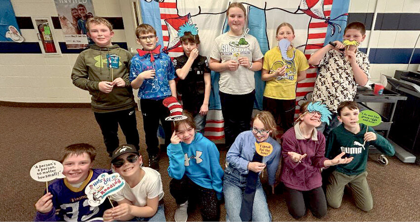 The fourth grade posed in front of the Dr. Seuss photo booth set up at the school.