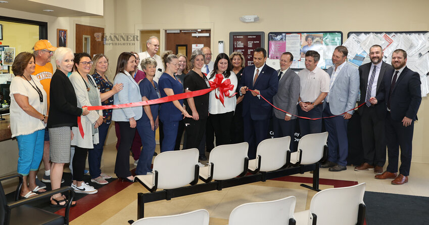 Dr. Ralph Alvarado, commission of Department of Health cuts the ribbon signifying the start of a significant renovation project at the Carroll County Health Department. Pictured are staff members at the local and  health department, state officials, county officials, and well-wishers.