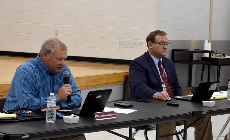 School Board Chairman William Robinson and School Director Preston Caldwell check out their new Chromebooks during the meeting.
