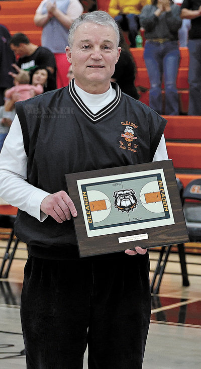 Randy Frazier holds a replica of the new Randy Frazier Court.