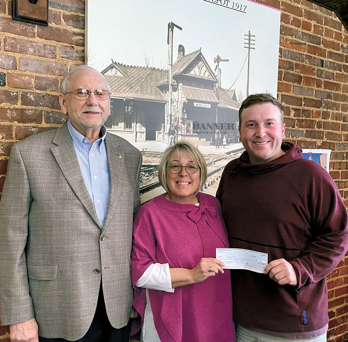 Ed Perkins, the longest serving member of the McKenzie Rotary Club, presented a history of the club on Tuesday. Pictured also is Sandi Roditis, president, who presented a check to Blake Cossey for the local Young Life chapter.