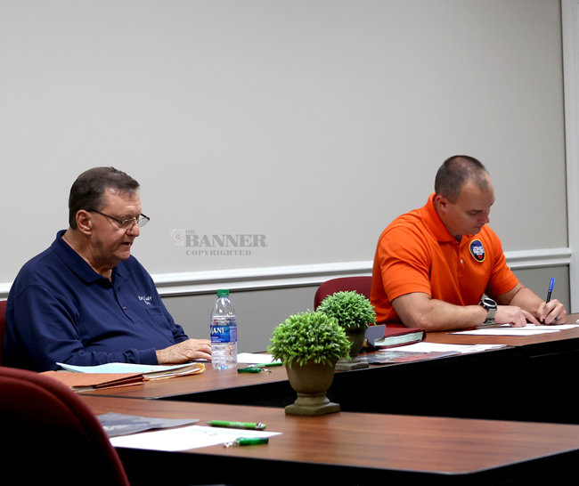 Danny Brawner, general manager, and Ryan Drewry, office manager of Carroll County Electric at the monthly Board of Directors meeting.