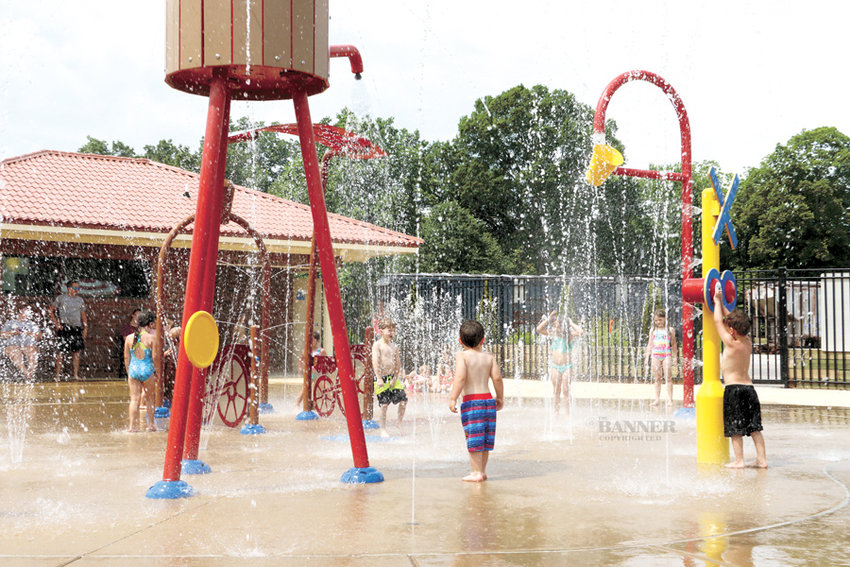 Several children playing at the splash pad.