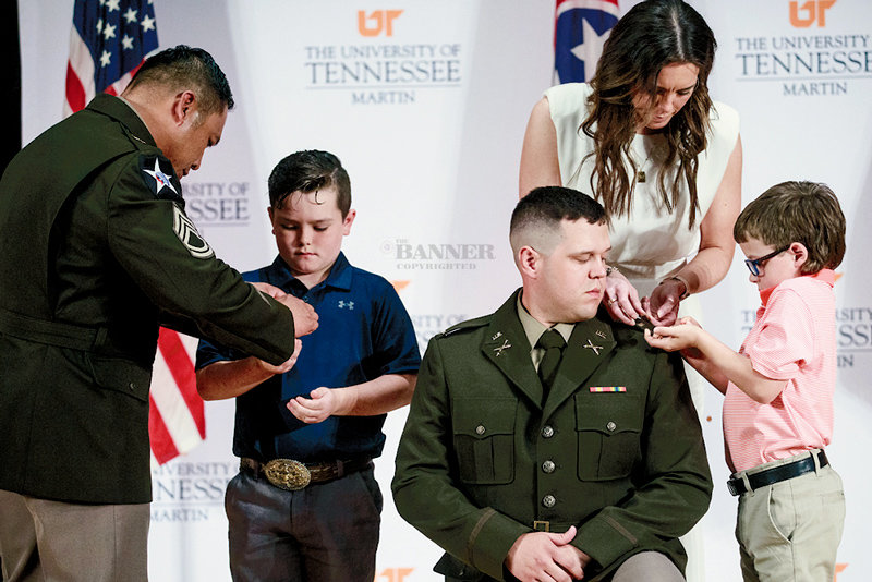 Austin Maxwell (center) is pictured with Sgt. First Class Kenneth Acfalle, senior instructor of military science, his sons, Jack and Easton, and his wife, Rebekah.