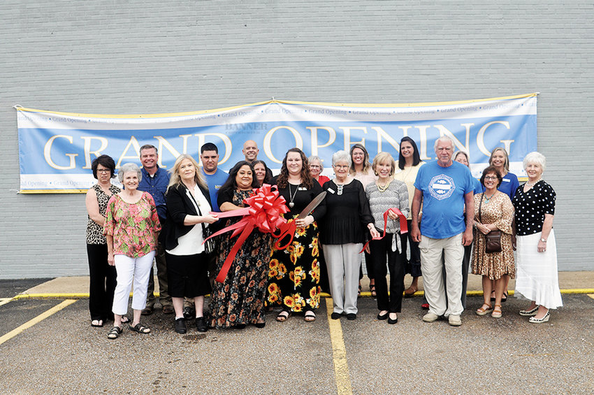 Pictured are city and county officials along with Farmers Home Furniture employees and friends celebrating the store&rsquo;s grand opening and ribbon cutting.