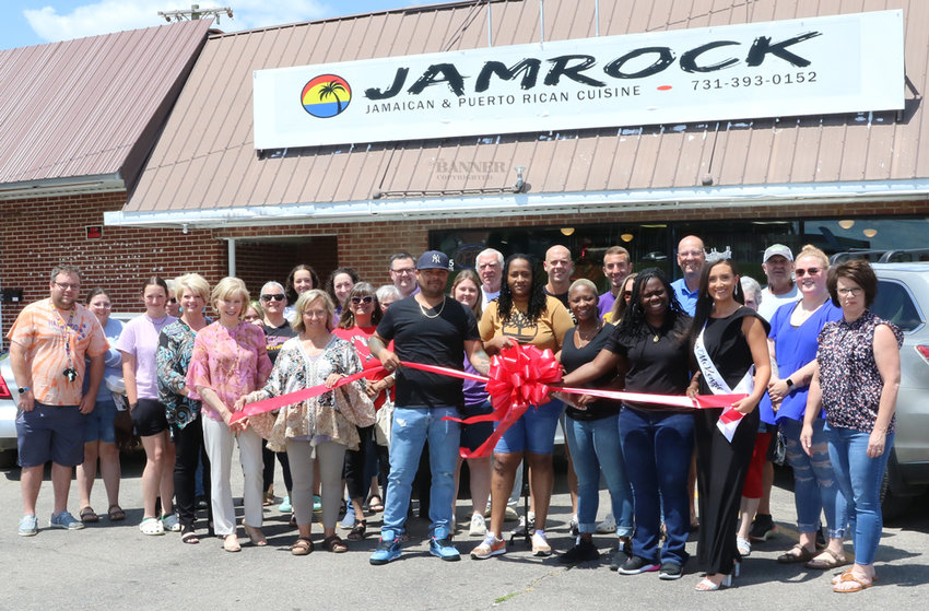 City officials, Bethel friends, and community members celebrate JAMROCK&rsquo;s ribbon cutting with the restaurant&rsquo;s owners.