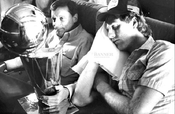 While Larry Bird snoozes on the flight home from Houston following the Celtics&rsquo; championship-clinching victory over the Rockets in May 1981, trainer Ray Melchiorre guards some recently acquired hardware.