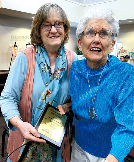 Denise Sam (left) presents the annual Friends of the Arts Award to Carolyn Potts of McKenzie.