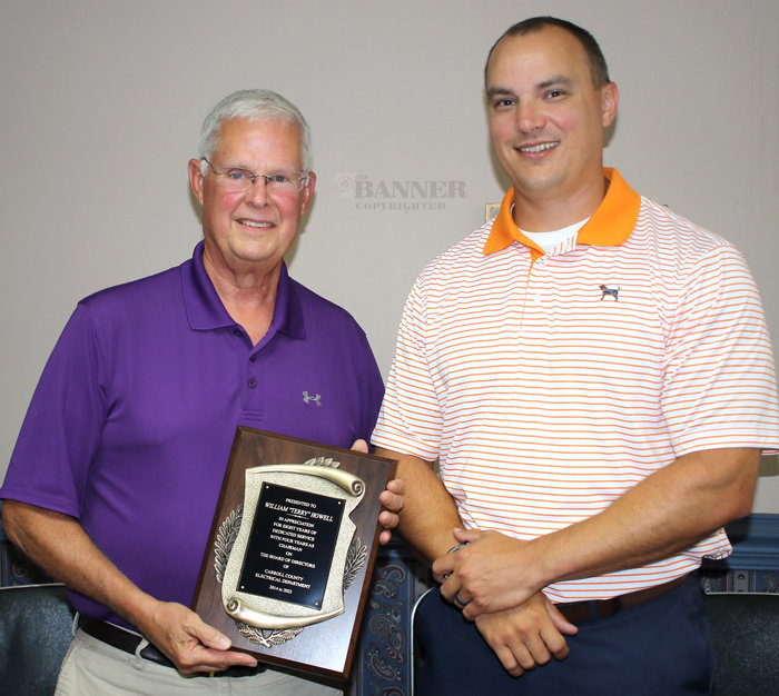 (L to R) Terry Howell was presented a plaque by Ryan Drewry for his service on the Carroll County Electric Department Board of Directors. Howell served eight years, four of which included the chairmanship.