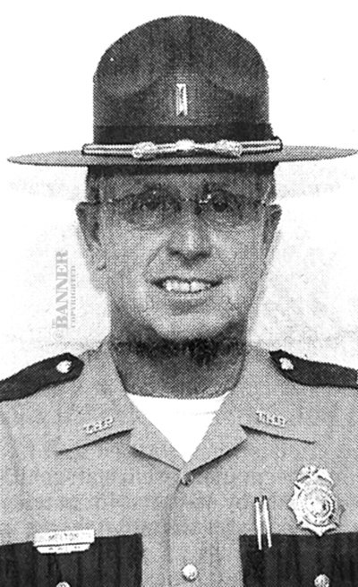 State Trooper Robert Earl Melton saves a woman from burning residence.
