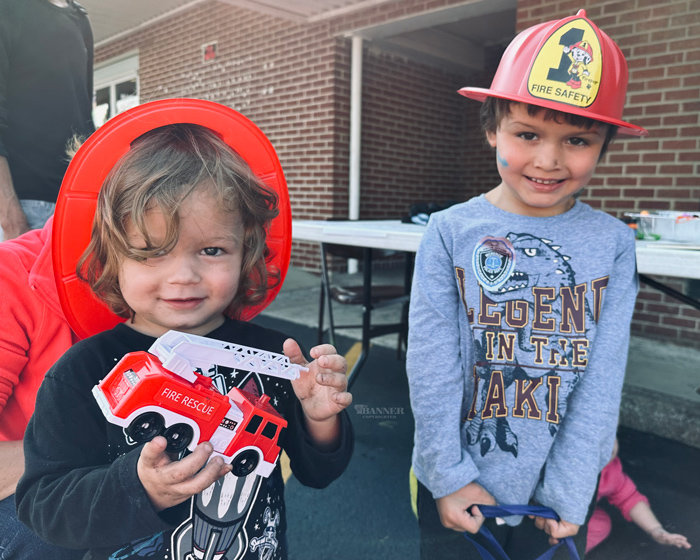 Gabriel and Kyler Ortiz enjoy their new fire helmets donated by the McKenzie Fire Department.