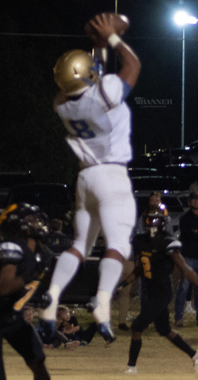 Eliljah Flowers (8) catches a touchdown pass surrounded by defenders.