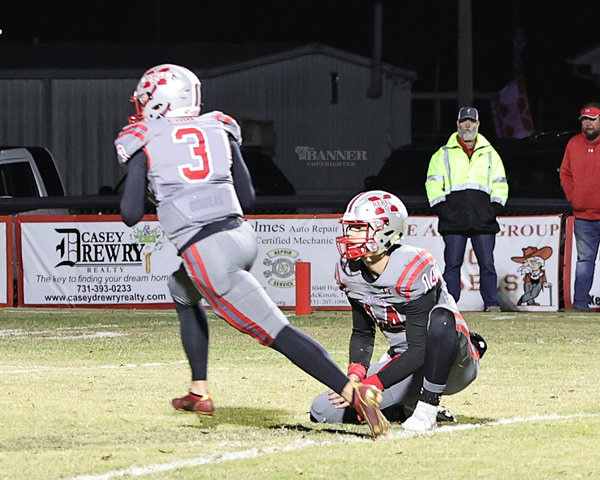 A fake point-after led Zach Aird (#3) to a 2-point conversion. When his progress stalled, his fellow team mates successfully pushed him into the end zone. Tate Surber (#14), who holds for the PAT, watches as Aird moves forward.