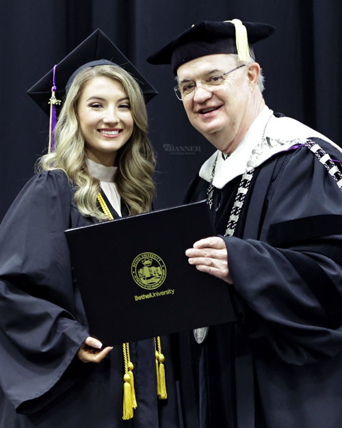 Dr. Walter Butler, president of Bethel, presents a diploma to Emma Martin of McKenzie. Martin graduated with a Bachelor of Science degree.