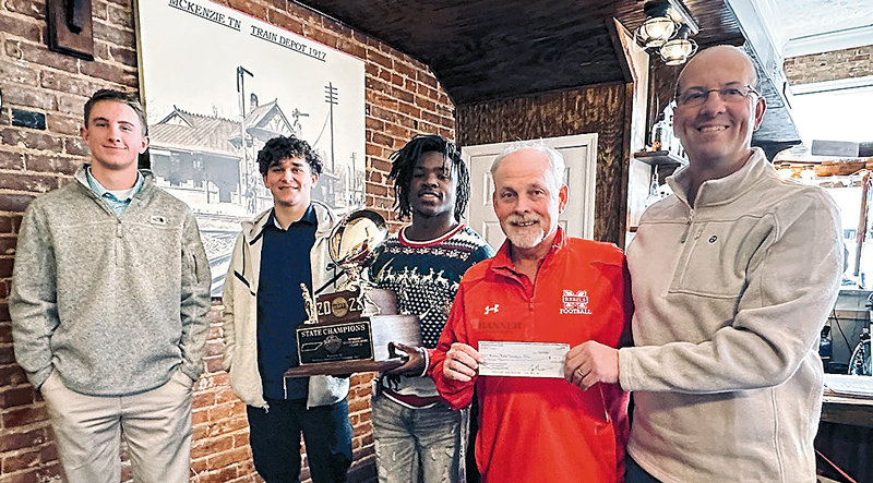 (L to R): Jackson Cassidy, Zack Aird, Marquez Taylor (holding the gold champion ball trophy), Coach Wade Comer and Rotary Vice-President Spiros Roditis.