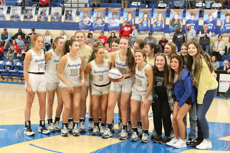 Huntingdon Fillies gather with Lilly Kee and her imprinted ball commemorating her 1,000th career point.