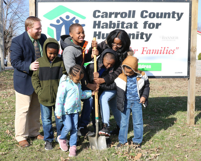 Ms. Schaccara Weatherford and her children &mdash; Zhayvareion (13), Jamair (10), Nazier (7), Jacaden (8) and Malaya (4) break ground for their new home at the intersection of Randle and Magnolia Street. Andrew Stokes of Habitat cheers them on.