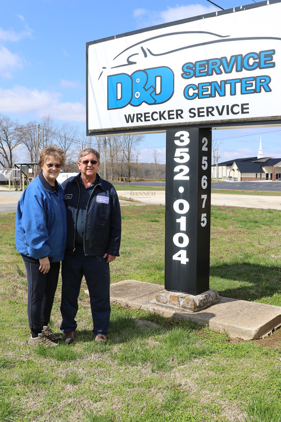 Melinda and David Ferguson stand beside the &lsquo;D&amp;D Service Center&rsquo; sign on the final day of operation on Friday, March 17.