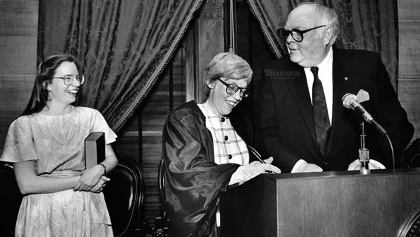 Carrie Daughtrey, left, smiles as her mother, Judge Martha Craig Daughtrey, adds her signature to documents on April 23, 1990, marking her swearing in by Governor Ned McWherter as the first woman member of the Tennessee Supreme Court.