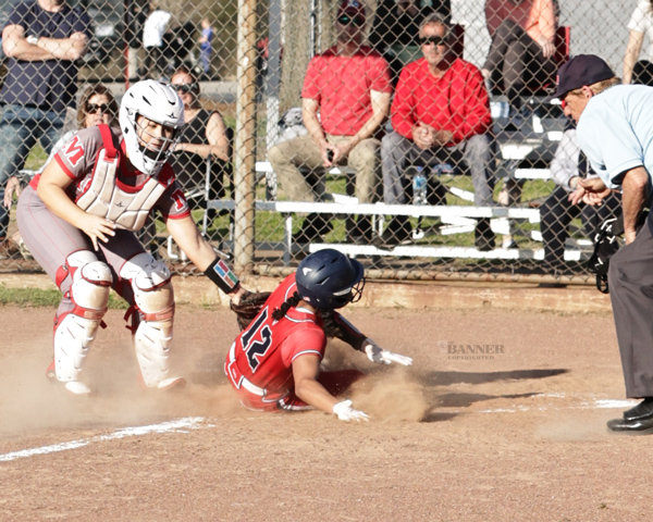 Kassidy Brown tags a Henry County player at home for an out.