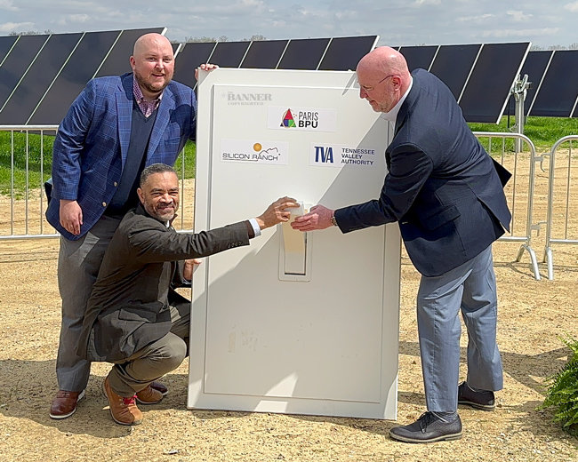 Matt Brown of Silicon Ranch, Mark Yates of TVA and Terry Wimberley of Paris BPU symbolically flip a switch to connect the 6.75-megawatt solar farm to the Paris BPU electrical grid.