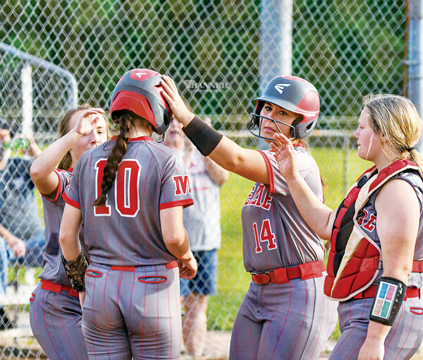 Auvenshine is met at home by her teammates to celebrate her bomb over the fence.