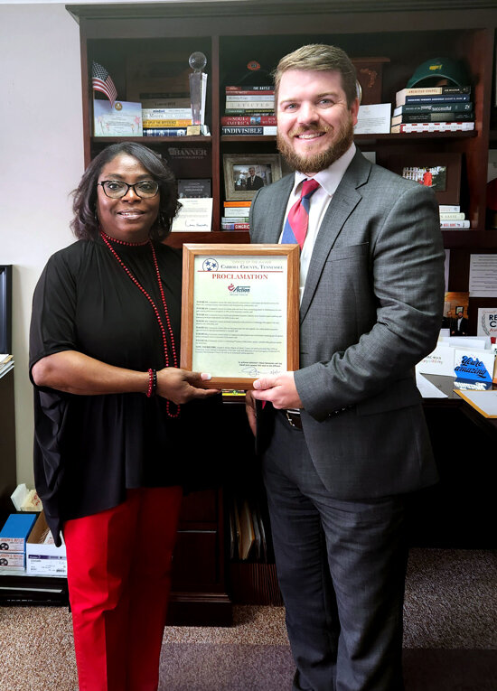 Mayor Joseph Butler presents signed a proclamation to Executive Director Cheryl Oglesby-Townes recognizing May as Community Action Month in Carroll County.