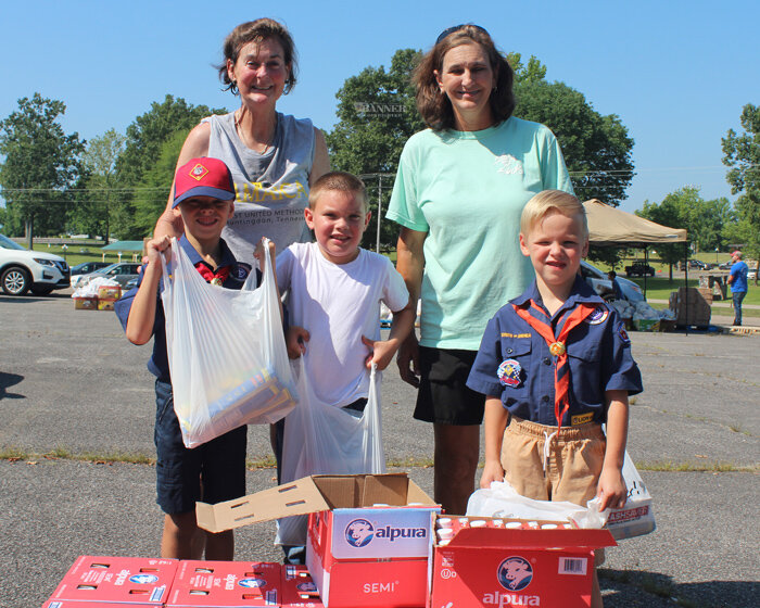 Volunteers Sterling MacRae, Austin Chasse, Griffin MacRae, Elizabeth Lott and Robin Belew helped package food into bags and boxes.