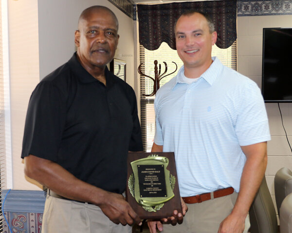 (Coach) David Hale was honored for serving four years on the Board of Directors of the Carroll County Electric Department. (L to R) Hale is presented a plaque by Ryan Drewry, general manager of CCED.