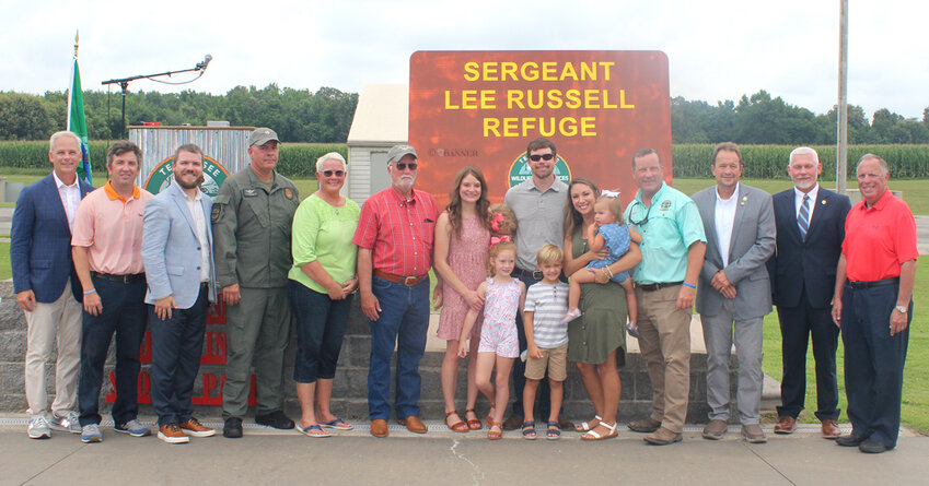 Sgt. Russell&rsquo;s family are pictured alongside TWRA members and community leaders in front of the Sgt. Lee Russell Waterfowl Refuge sign, which was unveiled during the dedication ceremony.