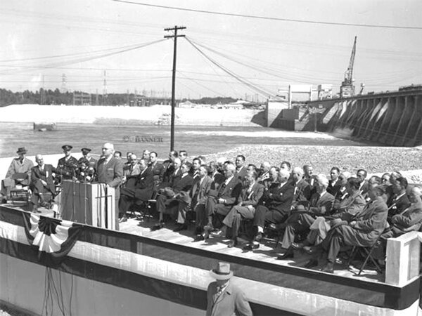 President Harry S. Truman is shown standing at the podium and dedicating Kentucky Dam on October 10, 1945.