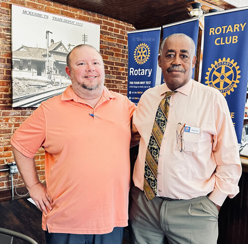 McKenzie Rotary President Jason Martin (left) welcomes Ricky Price (right) to the club.