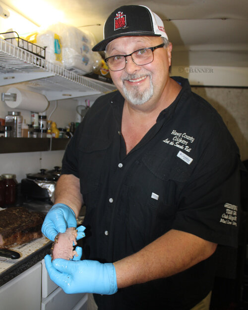 Chris Chadwick cuts a 19-pound beef brisket in preparation for Nights on Broadway.