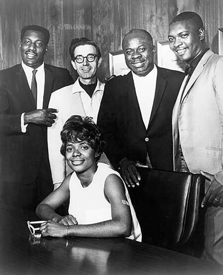 A 1967 publicity photo for Stax Records in Memphis (L to R):  Otis Redding, Jim Stewart, Rufus Thomas, Booker T. Jones, Carla Thomas (seated). The group pose for a photo after recording the hit duet &lsquo;Tramp&rsquo; that featured Carla and Otis on vocals.