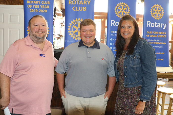 Drew Beeler (center) is welcomed into the Rotary Club by President Jason R. Martin and Vice President Christy Williams.
