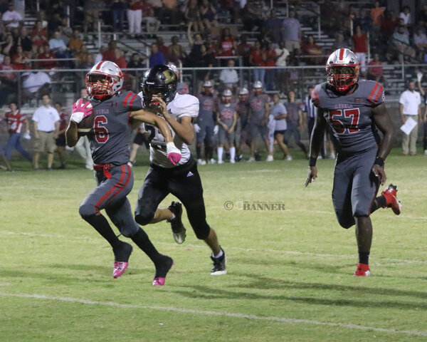McKenzie&rsquo;s Timmy Arline (#6) breaks away for good yardage setting up for a Rebel touchdown.