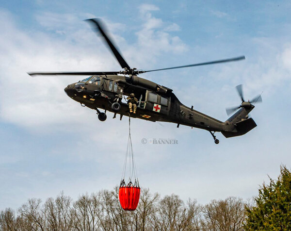 Tennessee National Guard UH-60 Blackhawk helicopter equipped with Bambi Bucket helping put out fires near Pigeon Forge in 2022.
